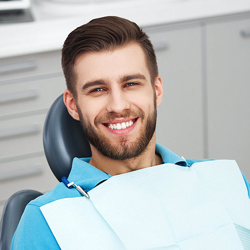 Young man sitting in the dental chair