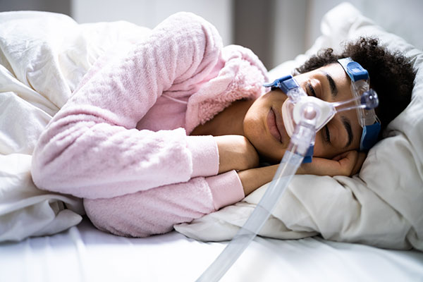 woman with CPAP mask sleeping